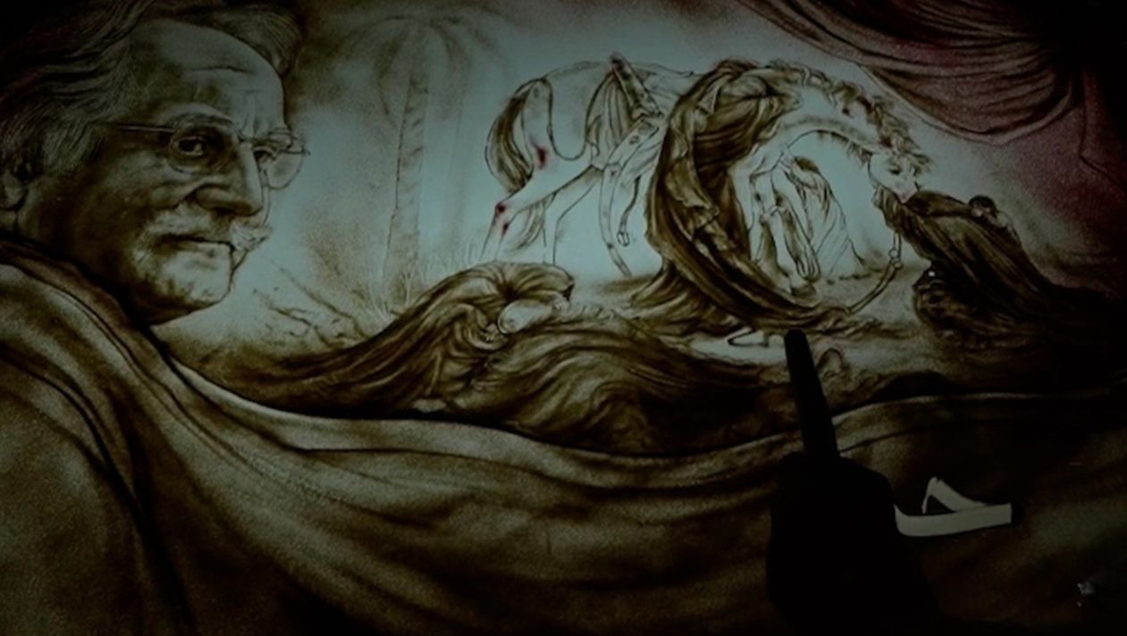 اجرای نقاشی شن چهره استاد فرشچیان روی تابلو عصر عاشورا +فیلم